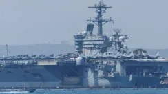 Gugus kapal induk Amerika Serikat beroperasi di perairan Timur Tengah saat Iran mengancam akan membalas setiap serangan sebagai perang total.